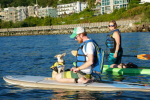 paddlers with dog on the water