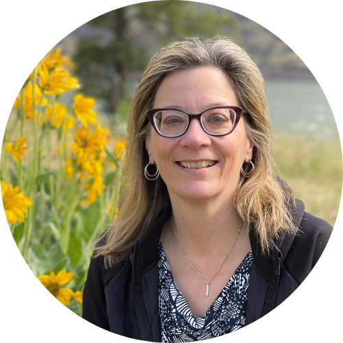 LeeAnne LeeAnne Beres, a white woman wearing glasses with blonde hair in front of sunflowers