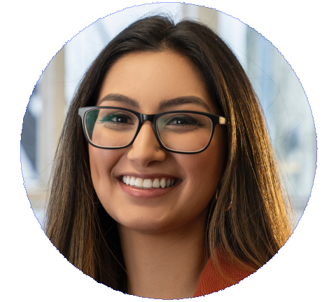 Denisse Guerrero a woman with long straight brown hair, brown eyes, glasses, and a large smile