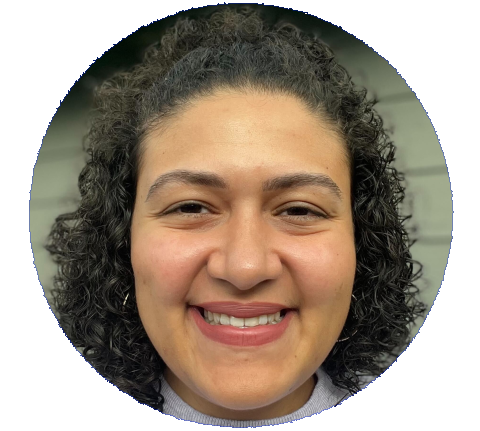 Headshot of Eada Al-Soodani with dark curly hair and brown eyes