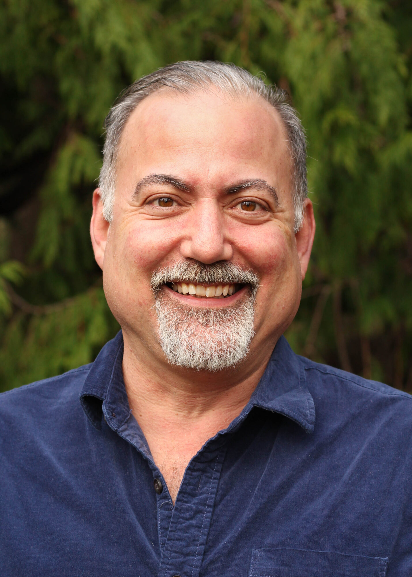 Picture of Peter Bloch Garcia with leafs in background 