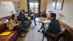 A group of people sitting in a representative's office inside the Washington State Capitol building