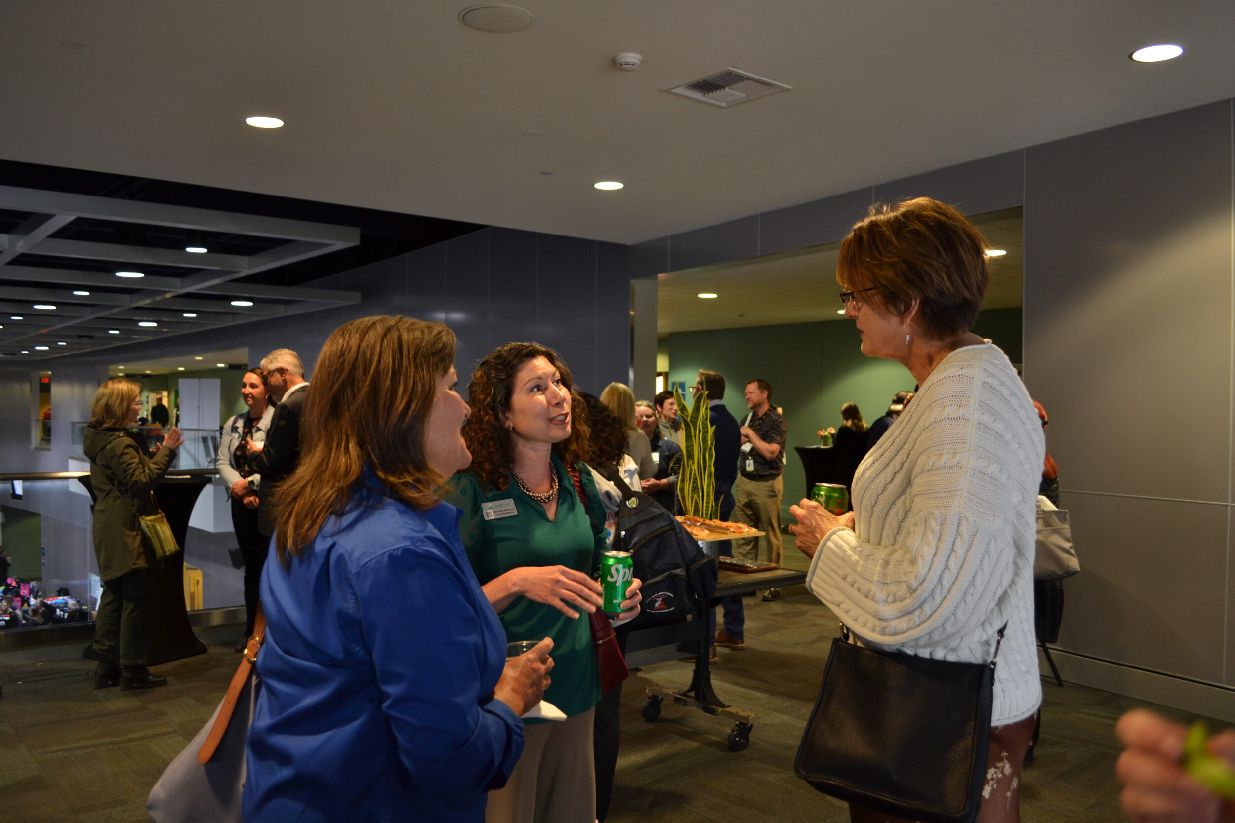 Group of three people talking at the conference reception